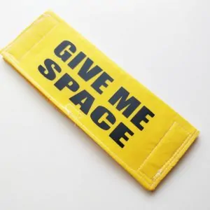 Yellow leash sleeve with bold give me space text